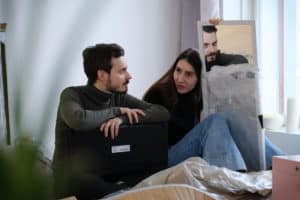 man-and-woman-sitting-in-bed-talking