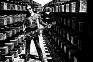 man-standing-with-guitar