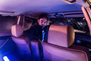 man-sitting-in-drivers-seat-of-a-car