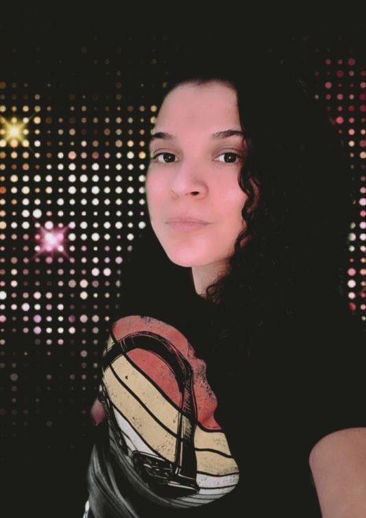 image of woman in front of black wall with whiet lights