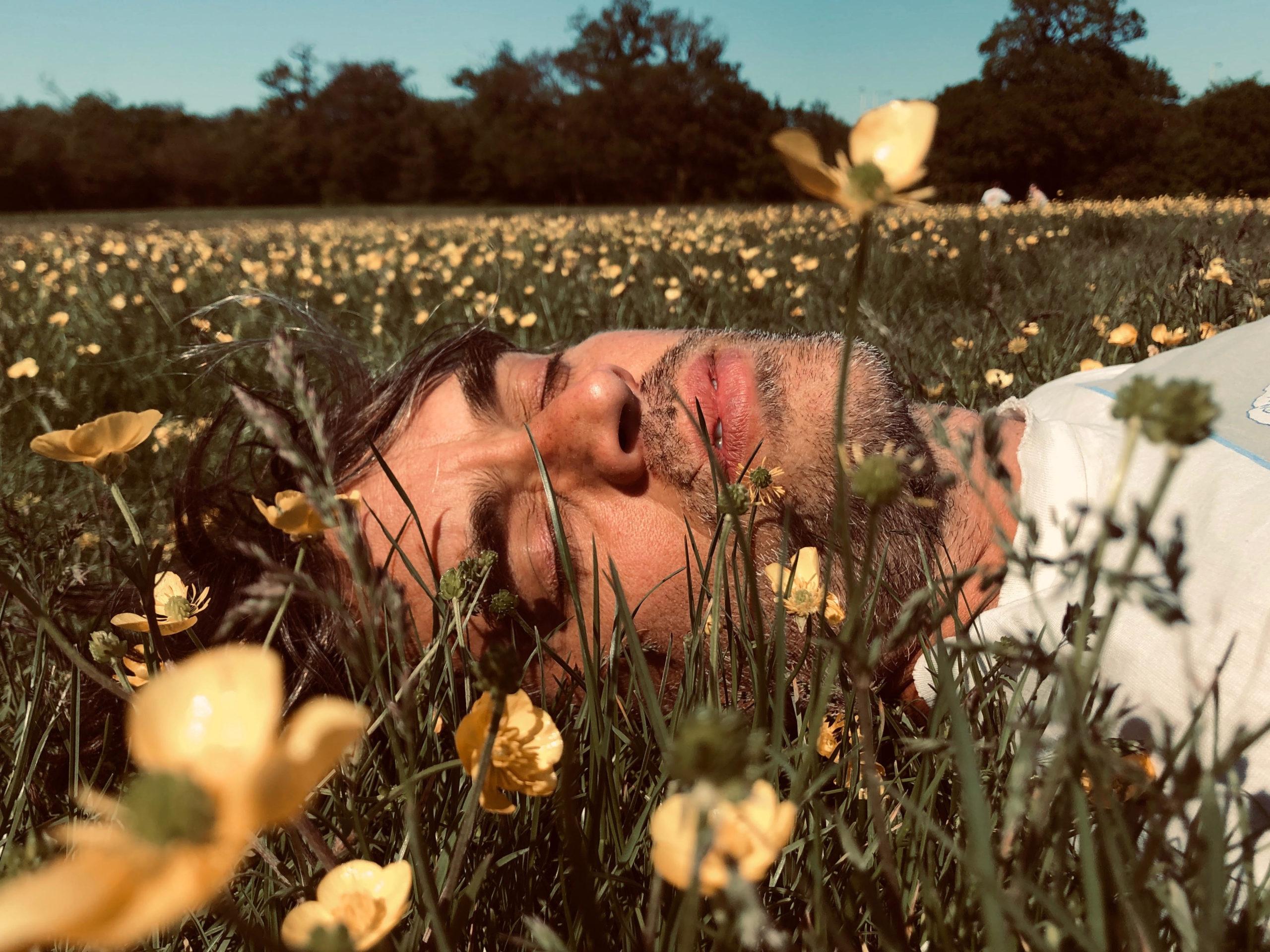man laying in grass