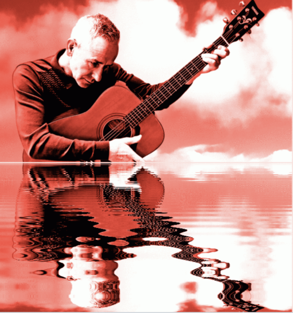 man standing in water playing guitar