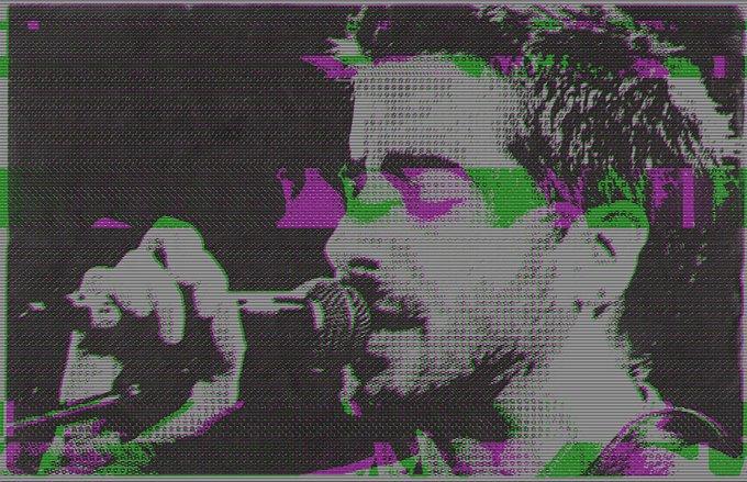 negative photo of man singing into microphone