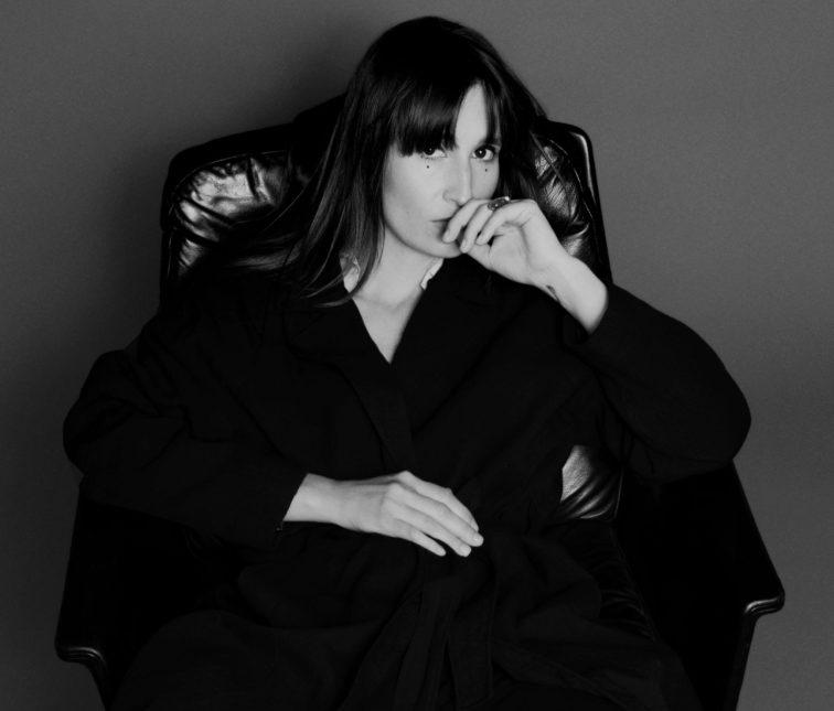 blakc and white image of woman sitting in a chair