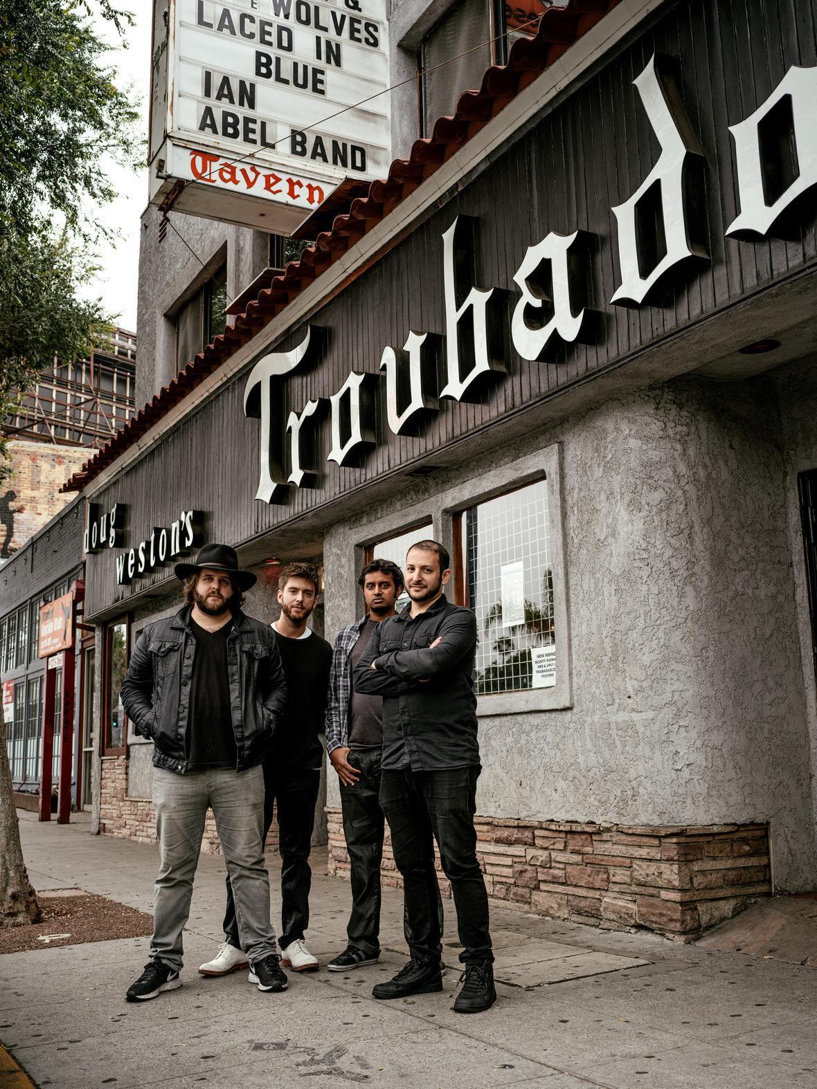 3 band members standing outside the troubador in LA