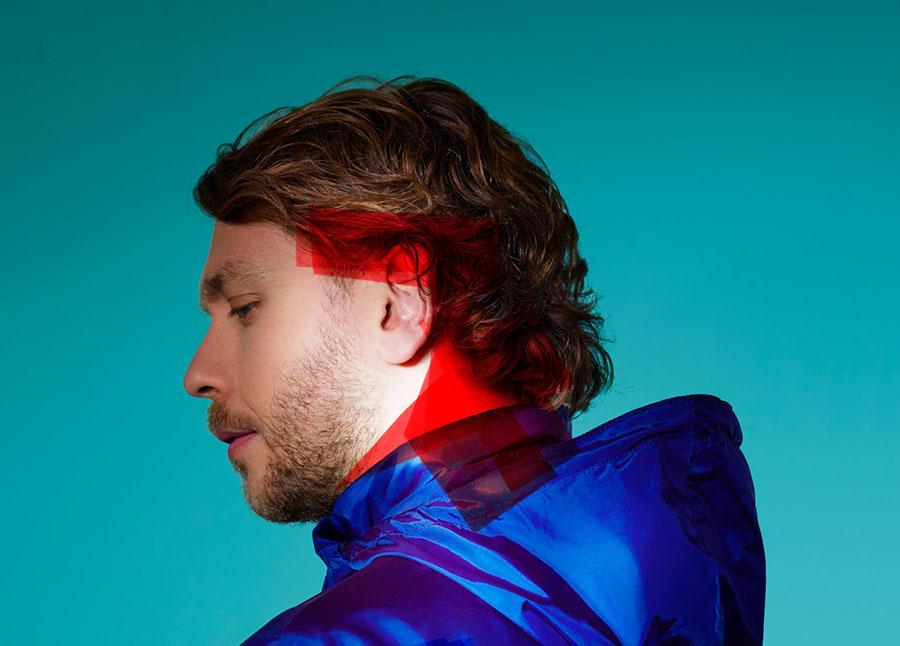 profile of a man in a blue jacket