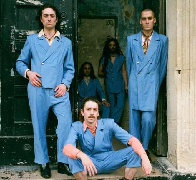 3 band members in blue suits