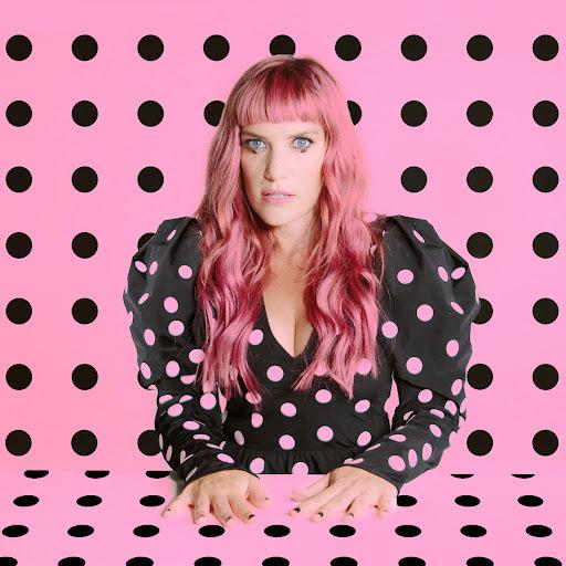 woman sitting in front of a polka dot wall