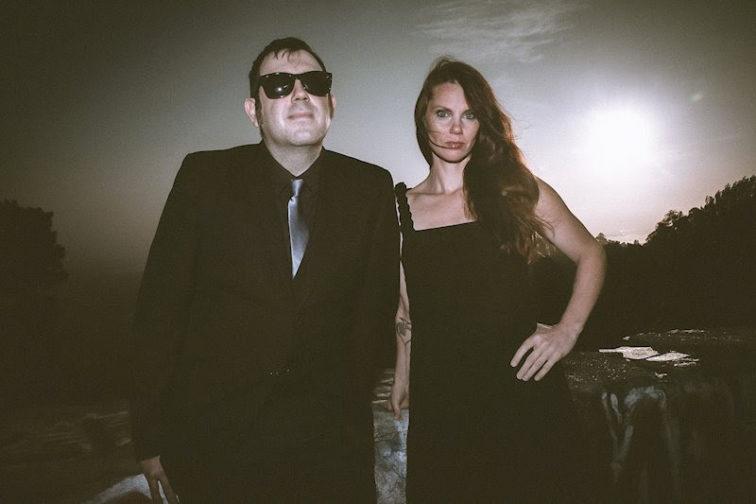 man standing next to a woman