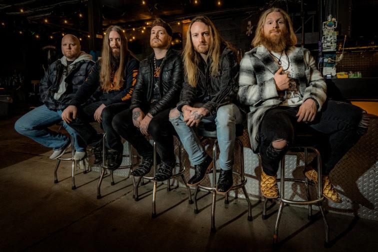 band members sitting on stools