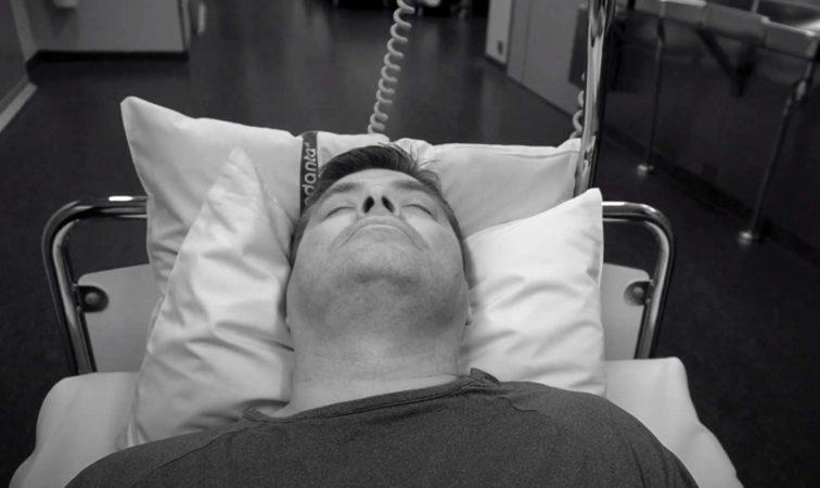 man laying on a hospital bed