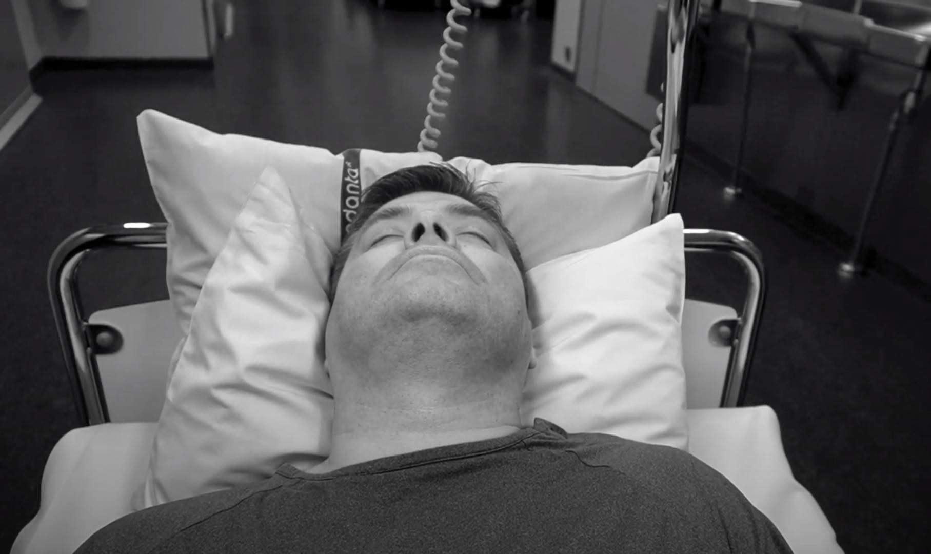 man laying on a hospital bed