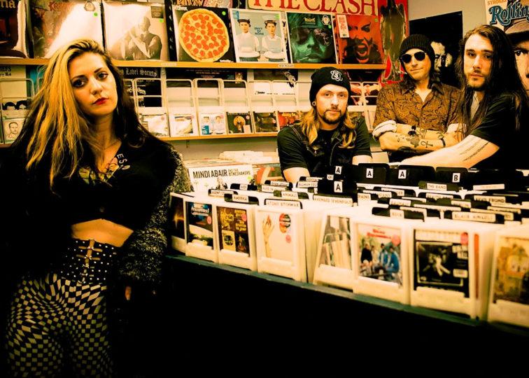 band members looking at records at a record store