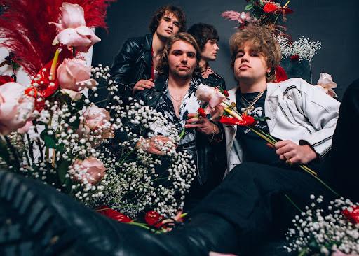 band members surrunded by flowers
