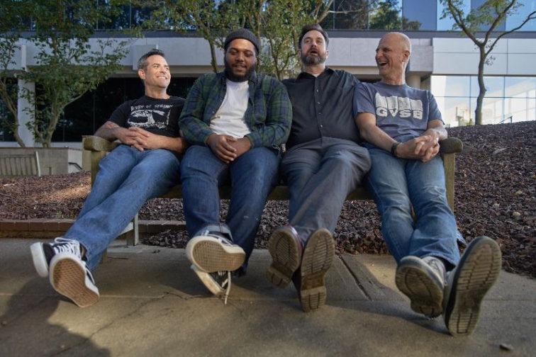 band members sitting on a bench