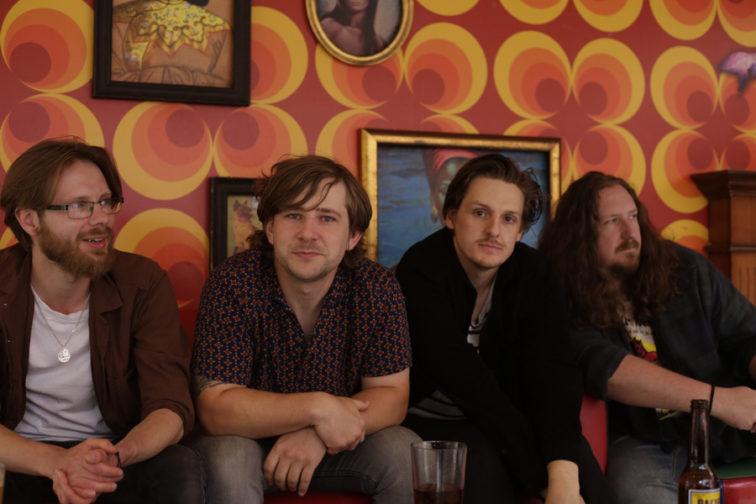 band members sitting on a couch