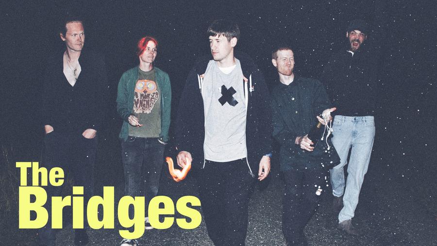 indie band members standing outside in the dark