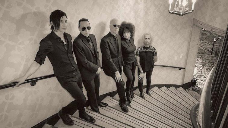 band members standing in stairs in an expensive home