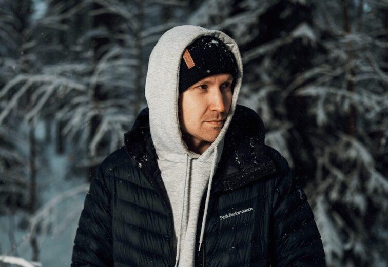 man standing in the woods covered with snow