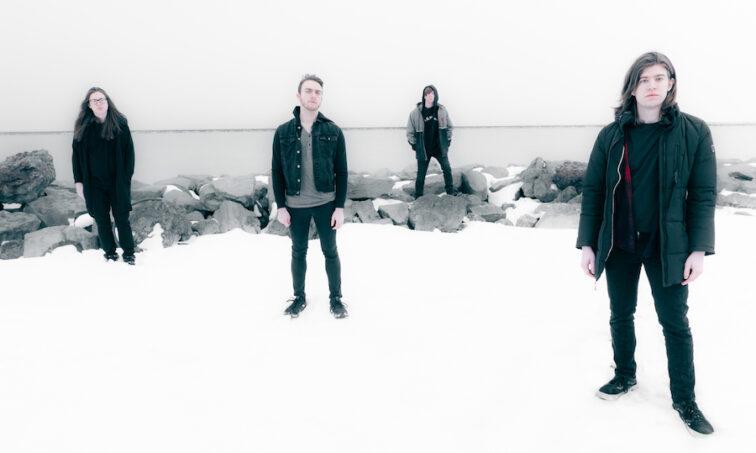 4 men standing outside on a cloudy day