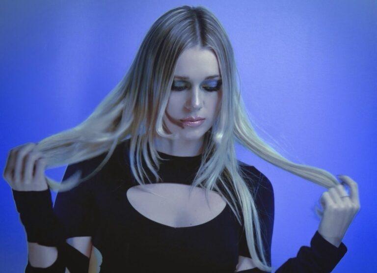 woman standing in front of a blue wall