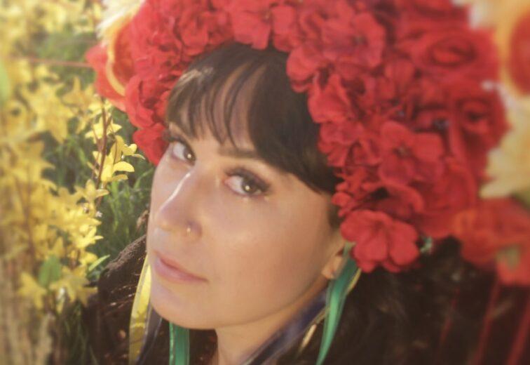 woman wearing a hat made of red flowers
