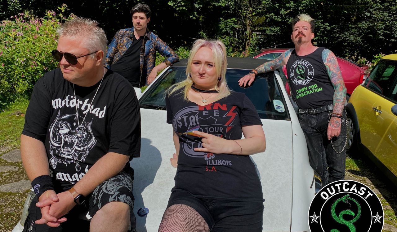 band members sitting on the hood of a car