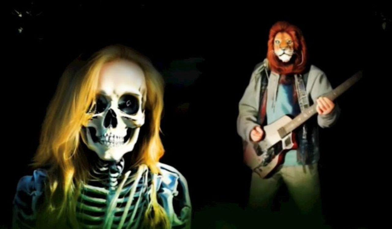 two people wearing a skeleton mask and a lion mask