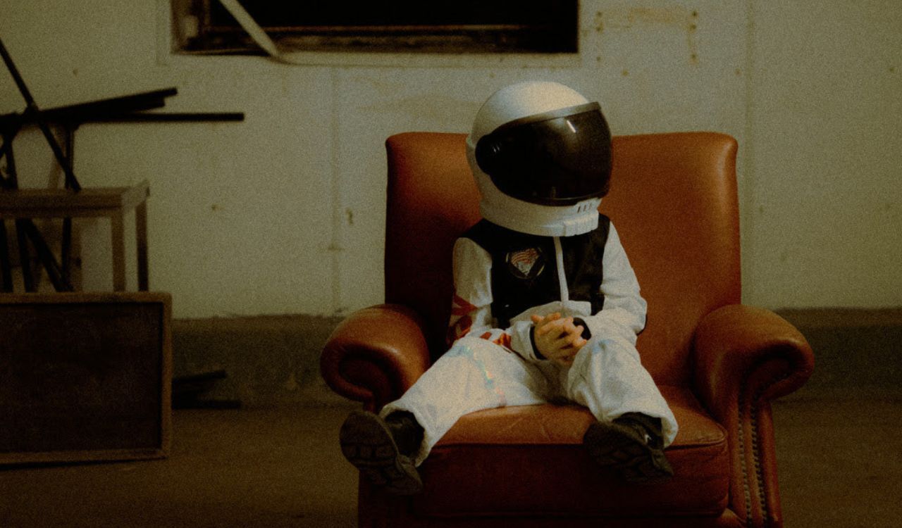 boy in a chair wearing a space suit
