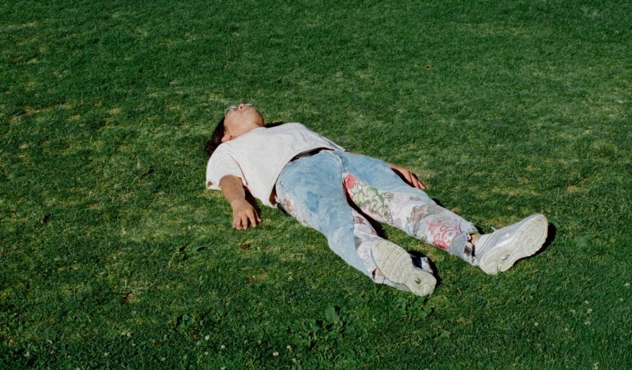 person laying in the grass