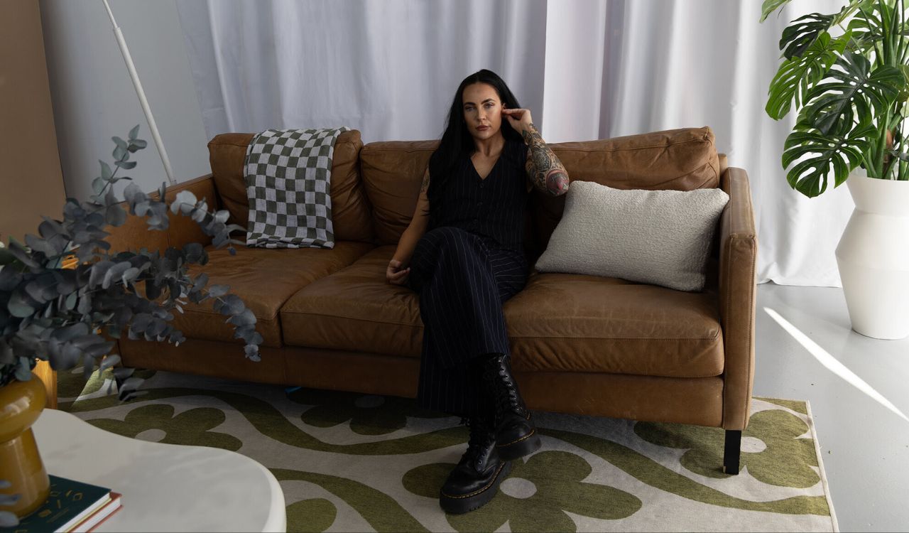 female musician sitting on a couch