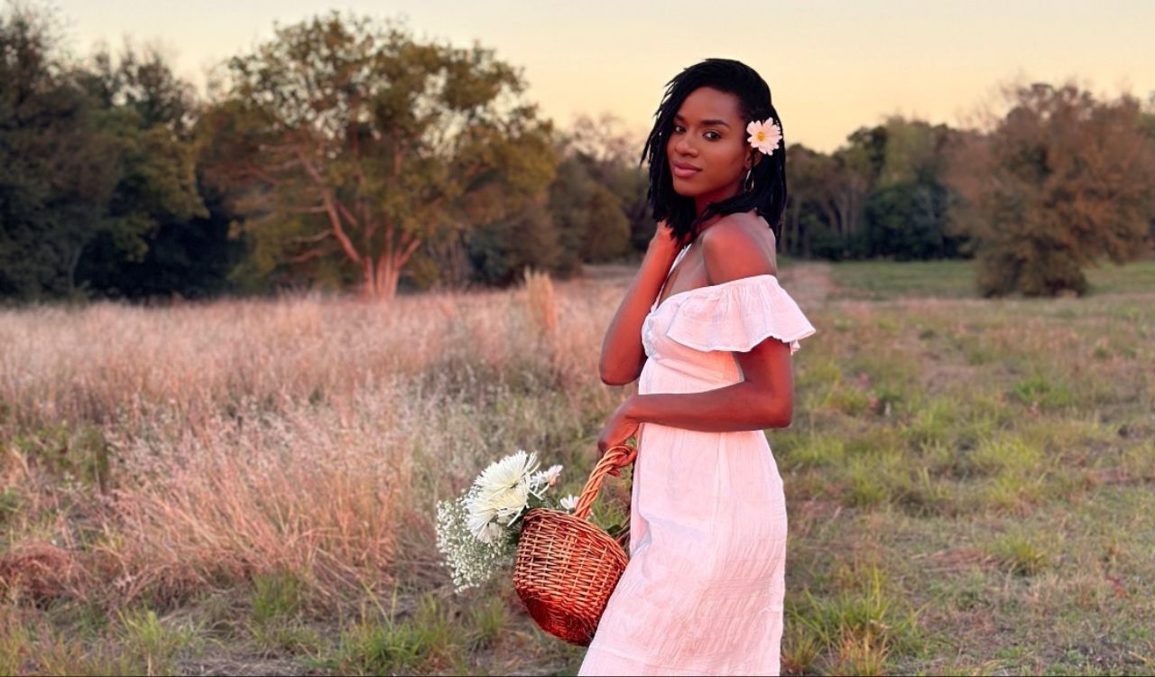 woman in a white dress in a field at sunset