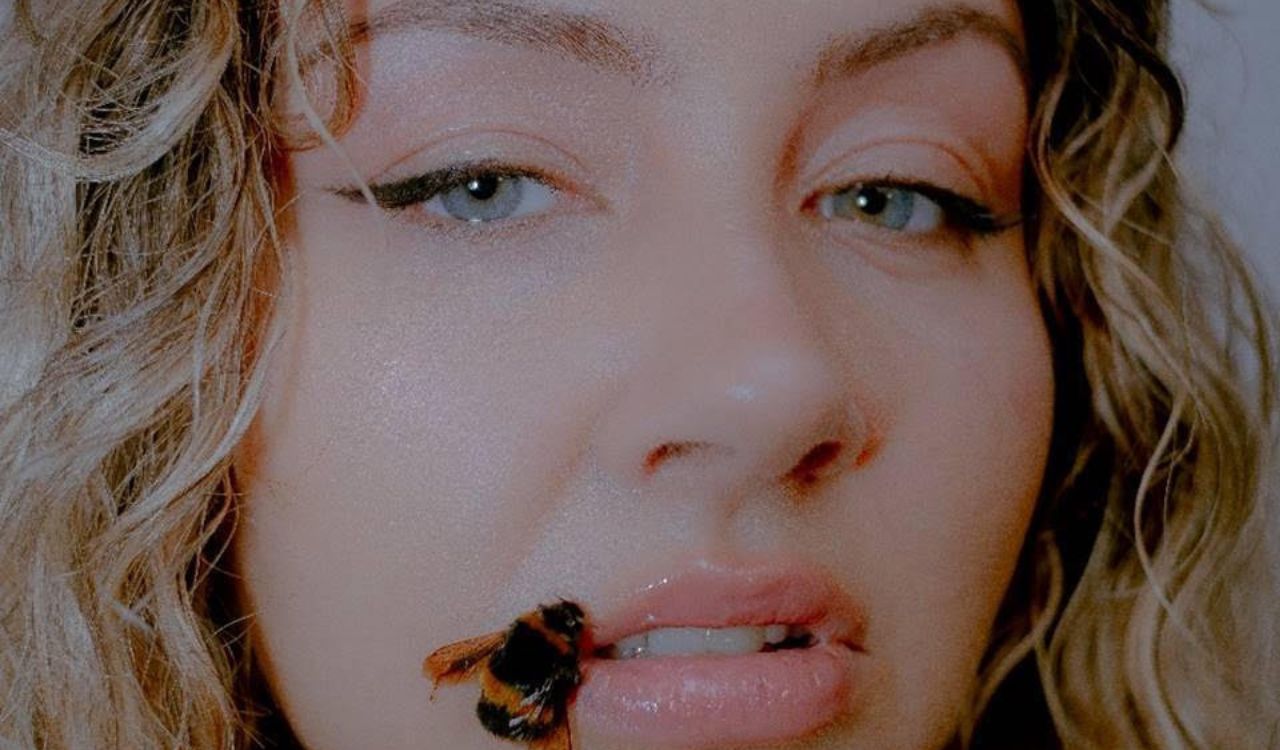 woman with a bee on her lip