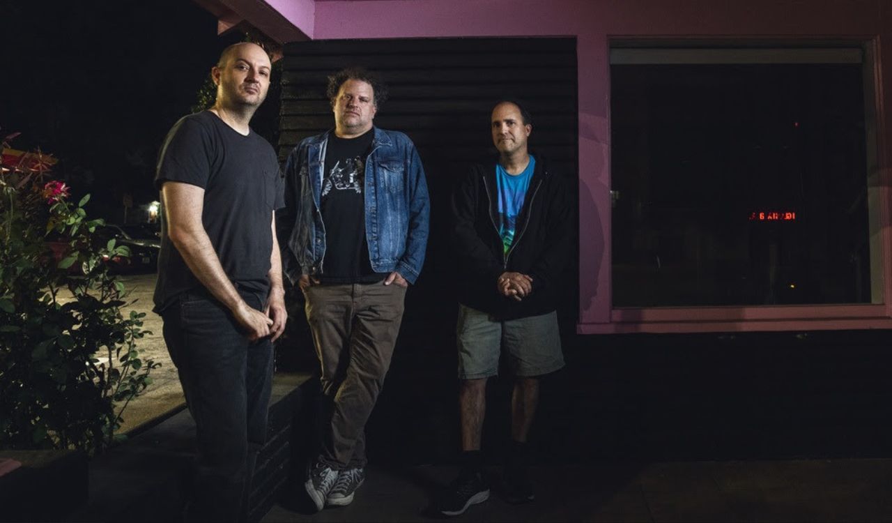 band standing on a front porch at night