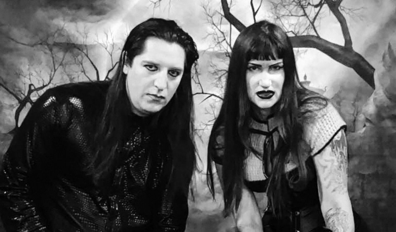 goth artists standing in a forest