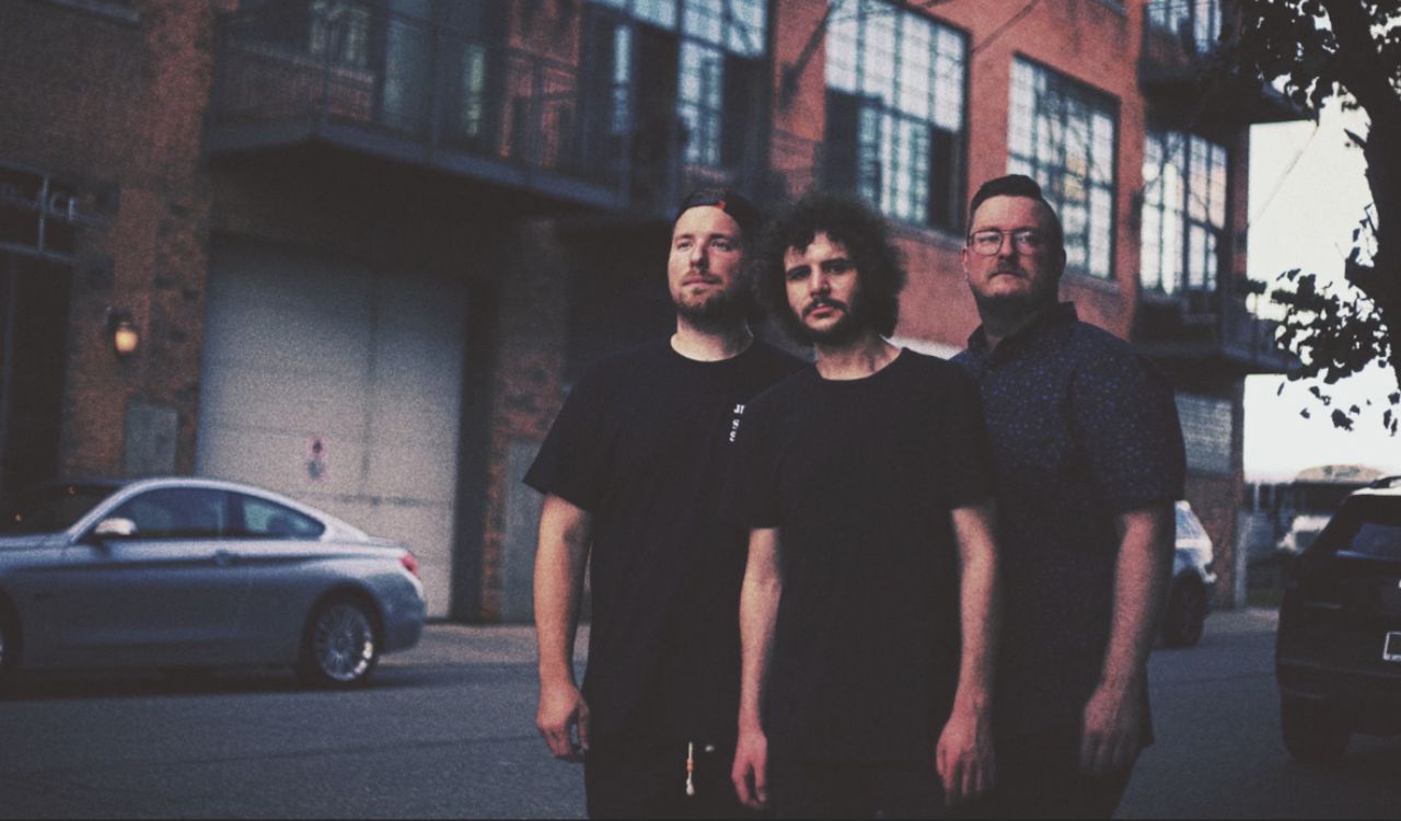 band standing in front of an old brick building