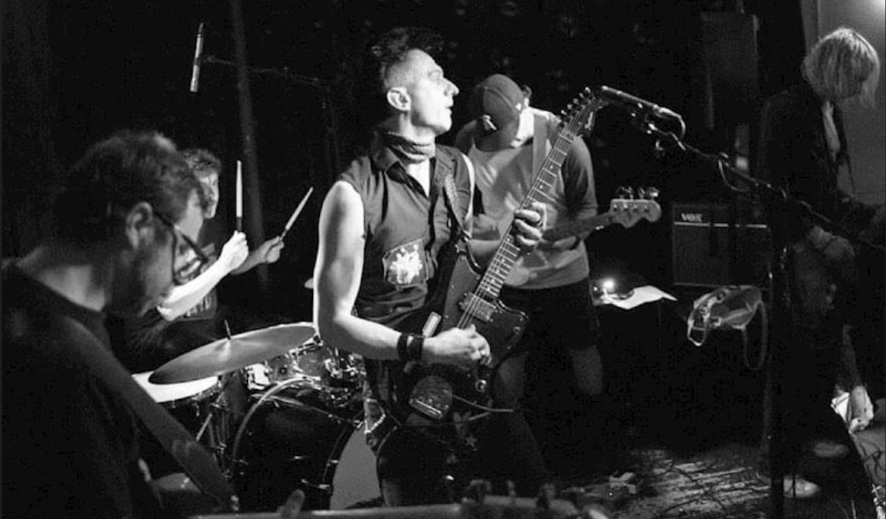 post punk band on stage with instruments