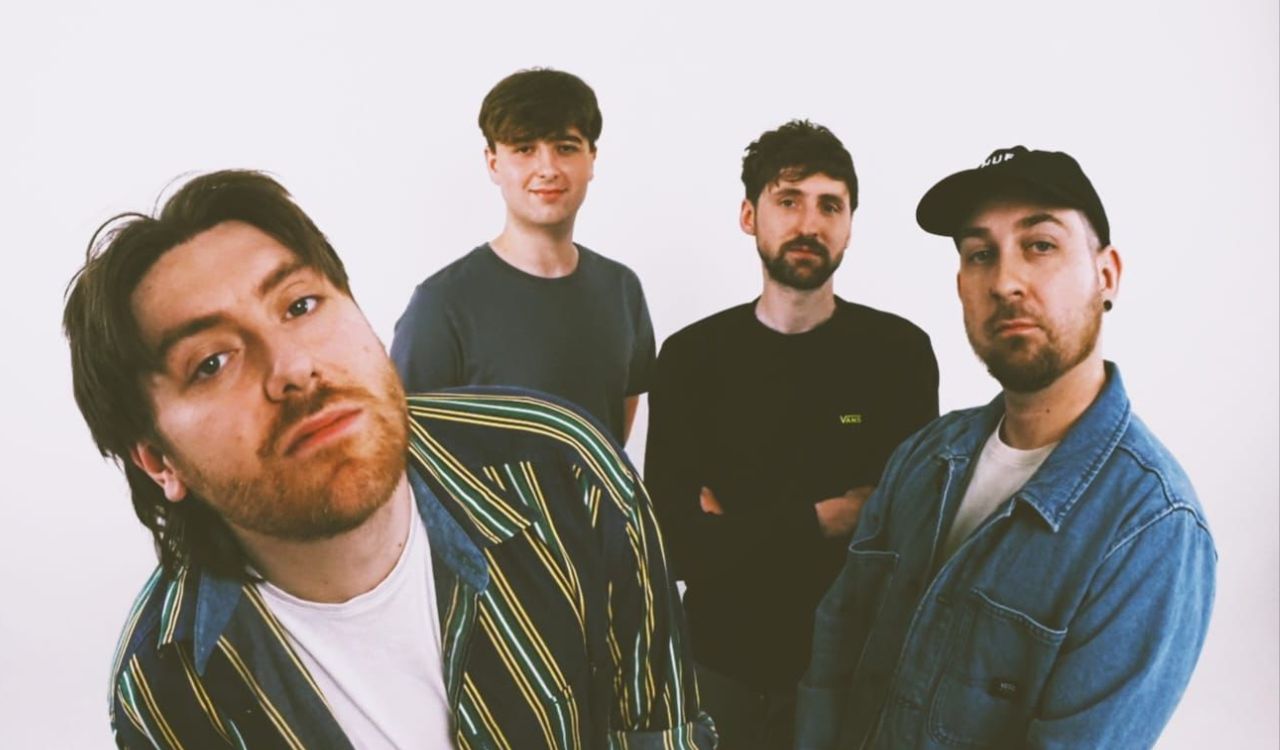 band standing in front of a white backdrop