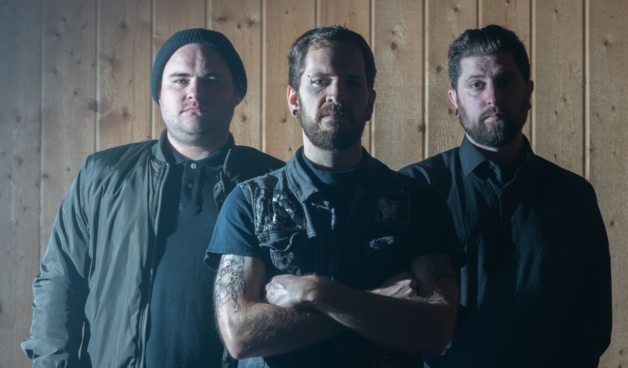 band standing in front of a wood wall