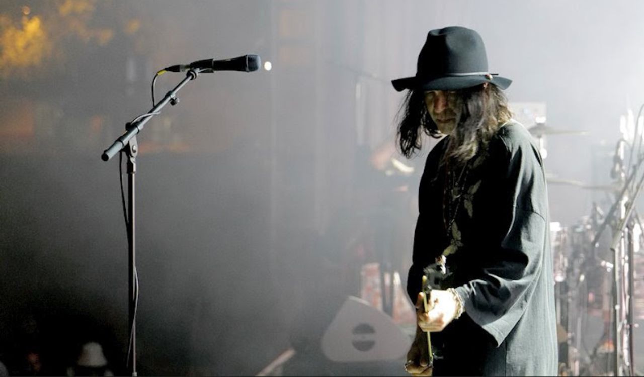 man playing guitar on stage