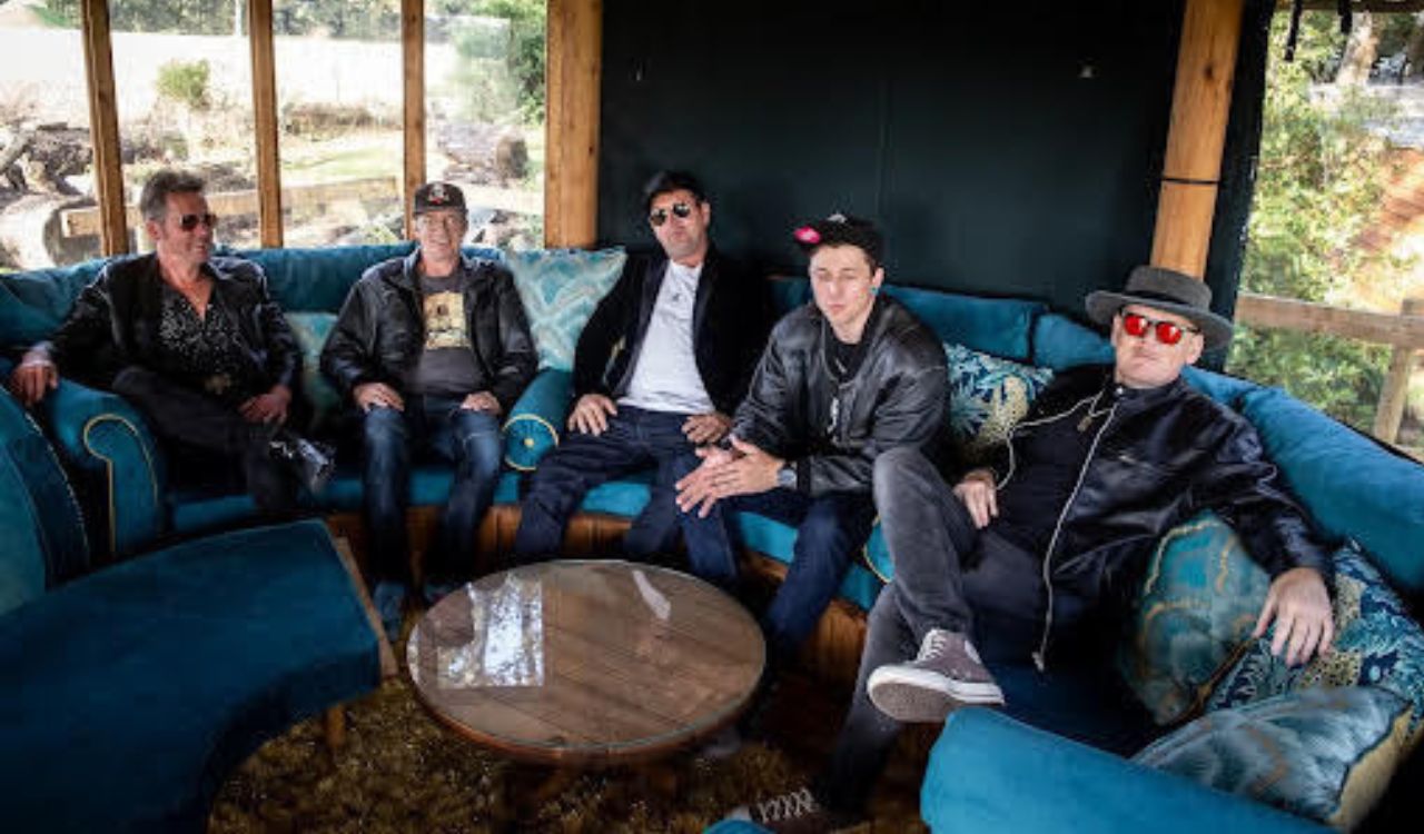 band sitting on a long curved couch