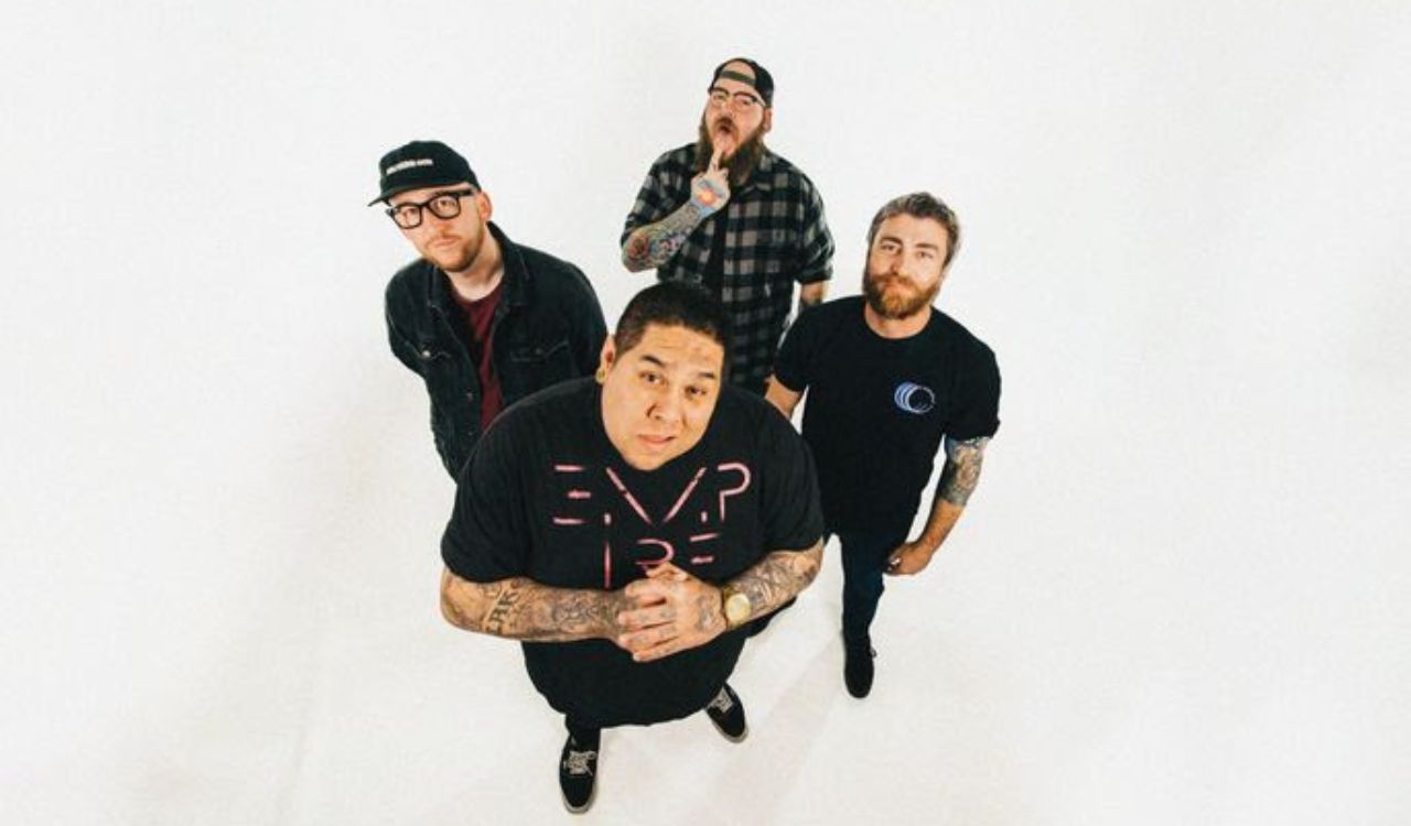 band standing in a blank white room