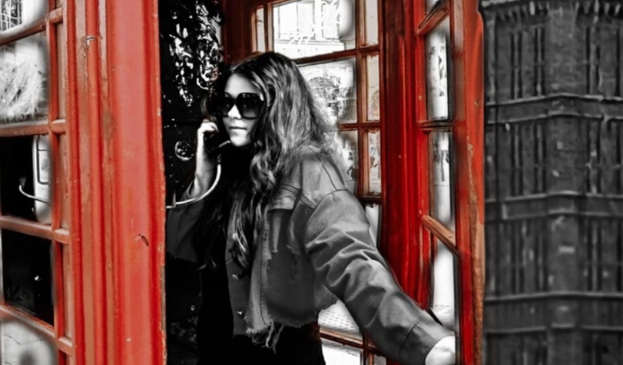 woman in a red phone booth