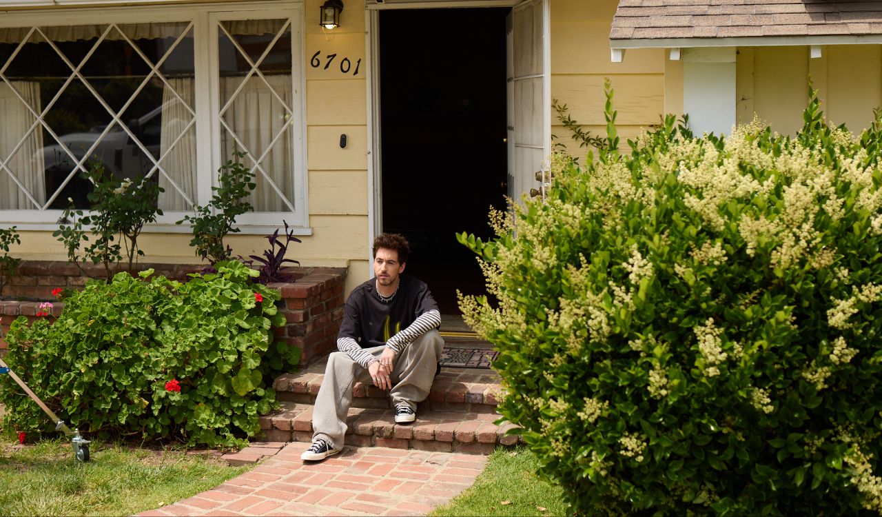 man sitting on the front steps of a house