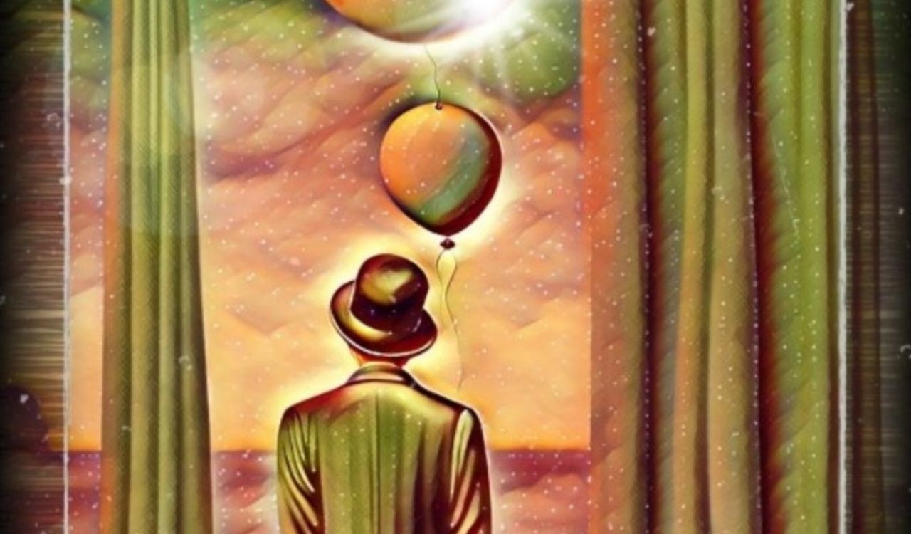 man looking at a hot air balloon out a window