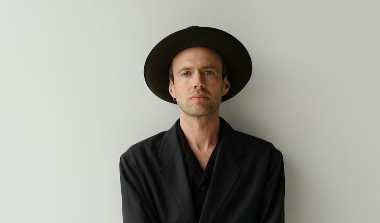 singer standing in front of a blank wall