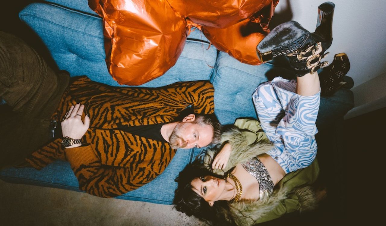 musicians laying on a couch