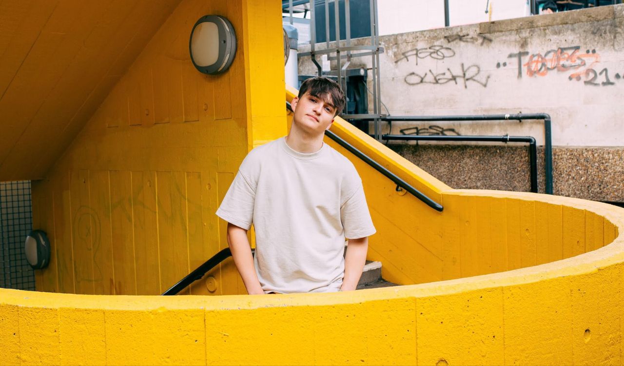 male singer standing on stairs