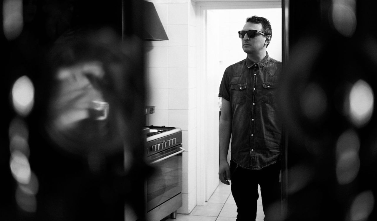 man standing in a dark kitchen