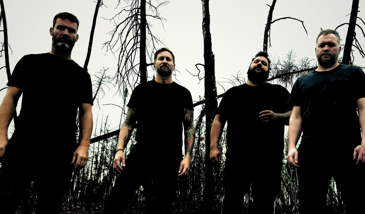 band standing outside in a dark forest